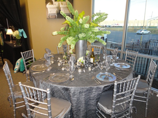 60 round table with silver linens and silver chiavari chairs